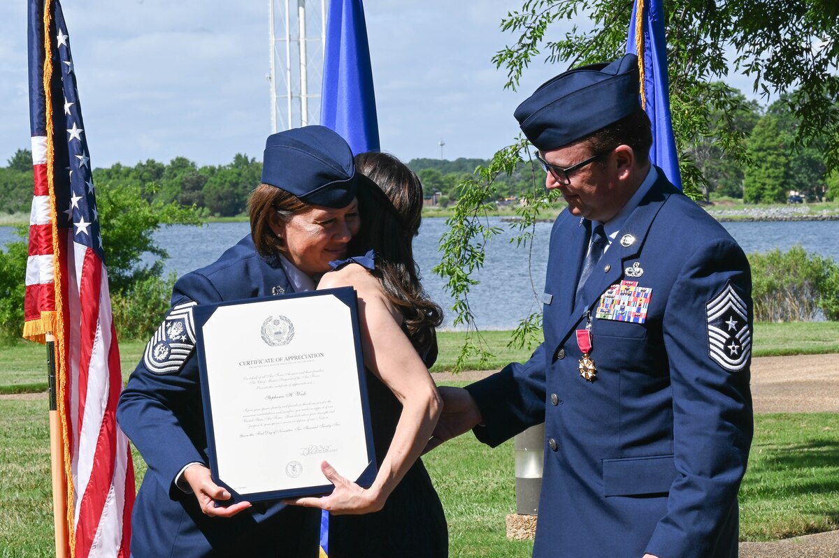 Chief Master Sergeant of the Air Force, JoAnne S. Bass, presents a letter of appreciation to the spouse of Command Chief of ACC, David Wade during his retirement ceremony on June 24, 2022, at Langley, AFB. Chief Wade will retire Nov. 1, 2022, after thirty years of service in the United States Air Force.
