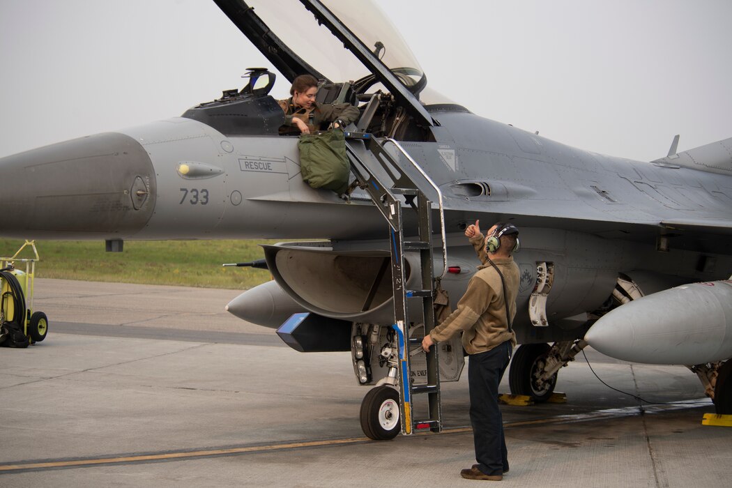 U.S. Air Force 1st Lt. Sammi “Force” Colombo, 35th Fighter Squadron F-16 Fighting Falcon pilot, Kunsan Air Base, Republic of Korea, gives the go ahead to remove the boarding ladder during preparations for a training sortie as part of the Red Flag 22-2 exercise at Eielson Air Force Base, Alaska, June 14, 2022. Known as the “Pantons”, the 35th FS performs air and space control and force application roles including counter air, strategic attack, interdiction, and close-air support missions. It employs a full range of precision ordnance, can operate day or night and in all weather conditions. The Red Flag Exercise was established in 1975 and serves as a two-week advanced aerial combat training exercise held multiple times a year by the USAF, alongside joint partner and allied air and ground forces. (U.S. Air Force photo by Staff Sgt. Ryan Lackey)
