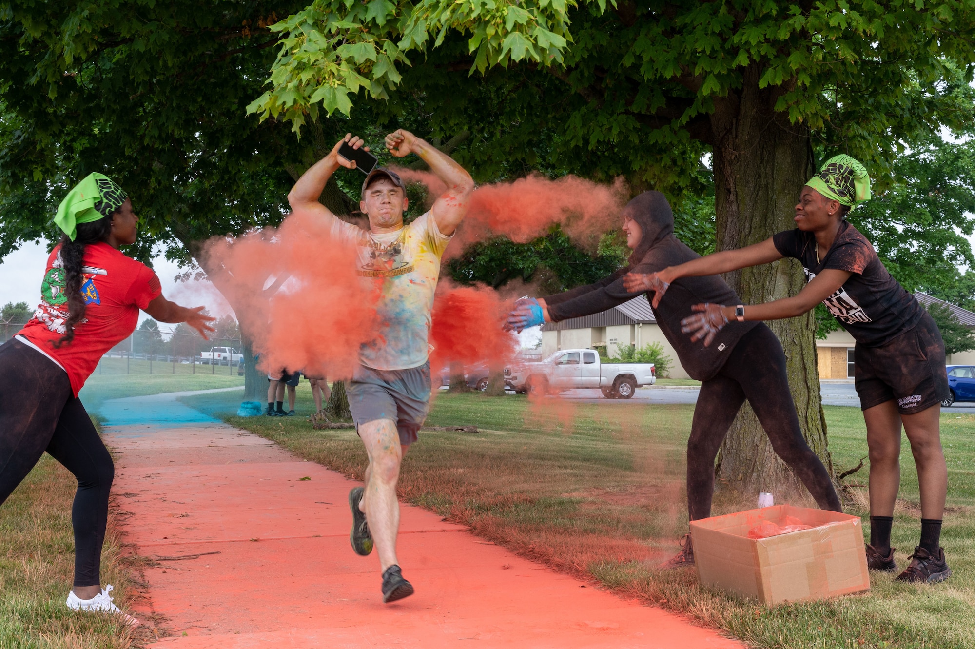 A member of Team Dover gets doused with powder during the Sexual Assault Prevention and Response Color Run at Dover Air Force Base, Delaware, June 24, 2022. SAPR color runs support the implementation of Sexual Assault Awareness Month activities and outreach beyond April. (U.S. Air Force photo by Airman 1st Class Cydney Lee)