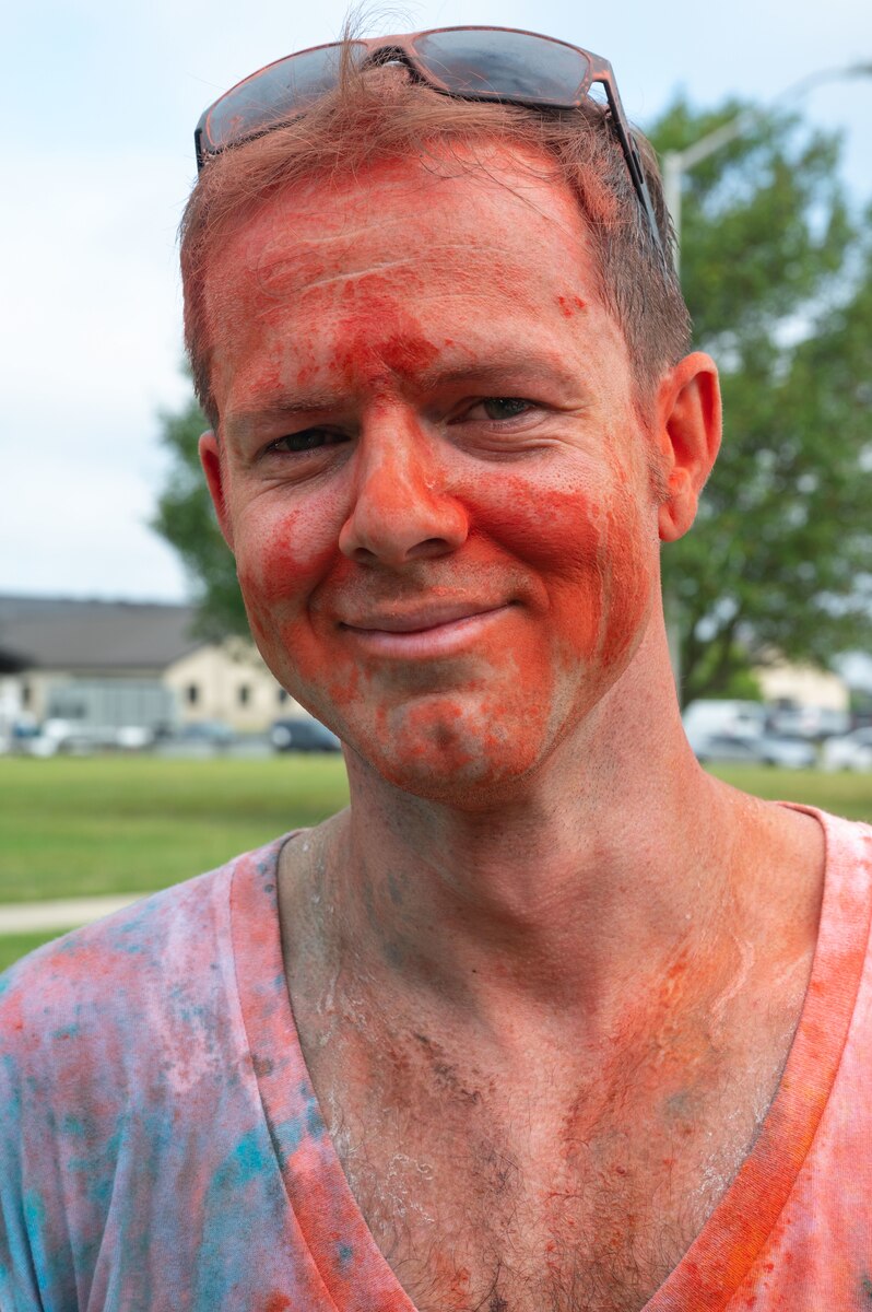 Tech. Sgt. Derreck Day, 436th Operations Support Squadron Survival, Evasion, Resistance, Escape specialist, poses for a photo after completing the Sexual Assault Prevention and Response Color Run at Dover Air Force Base, Delaware, June 24, 2022. SAPR color runs support the implementation of Sexual Assault Awareness Month activities and outreach beyond April. (U.S. Air Force photo by Airman 1st Class Cydney Lee)