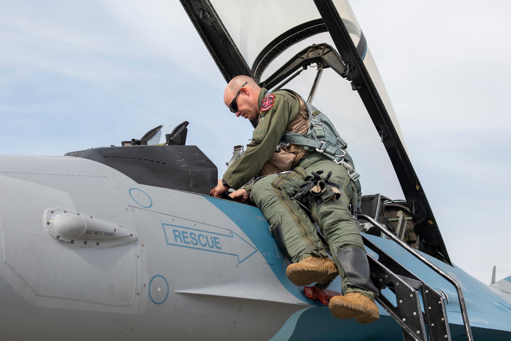 U.S. Air Force Lt. Col. Christopher “Coach” McGoffin, 18th Aggressor Squadron F-16 Fighting Falcon pilot, boards his aircraft before a training sortie as part of the Red Flag 22-2 exercise at Eielson Air Force Base, Alaska, June 16, 2022. The Aggressors are dedicated to playing the “red team” adversaries against “blue team” allies during Red Flag aerial training missions. The Red Flag Exercise was established in 1975 and serves as a two-week advanced aerial combat training exercise held multiple times a year by the USAF, alongside joint partner and allied air and ground forces. (U.S. Air Force photo by Staff Sgt. Ryan Lackey)