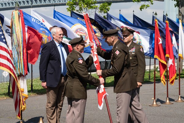 Lt. Gen. Scott A. Spellmon, Commanding General of the U.S. Army Corps of Engineers, passes the North Atlantic Division's colors to the incoming commander, Col. John P. Lloyd June 24, 2022, during a change of command ceremony at Fort Hamilton's Bluff Park in New York.