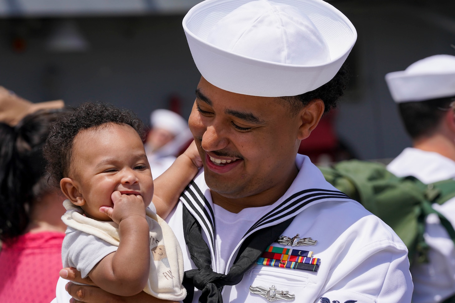 Sailor hugs baby