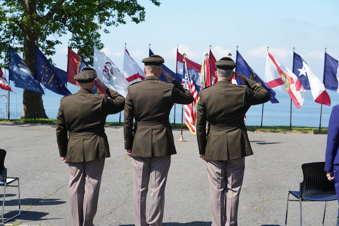 The North Atlantic Division change of command official party, Col. John P. Lloyd, incoming division commander; Lt. Gen. Scott A. Spellmon, commanding general of USACE; and Maj. Gen. Thomas J. Tickner, outgoing division commander, salute the colors during the playing of the National Anthem.