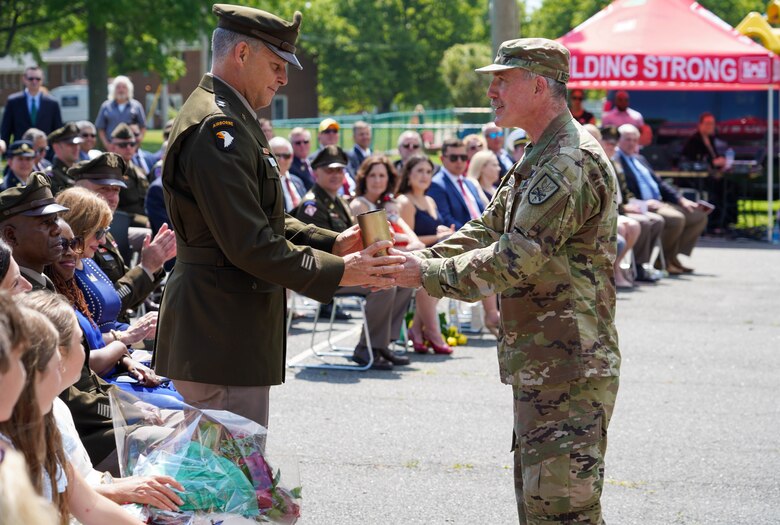 Col. Ray Mechmann, 9th New York Field Artillery Regiment presents a shell casing to Maj. Gen. Thomas Tickner, former commanding general of the USACE North Atlantic Division, as a remembrance of his honor salute during the June 24 change of command.