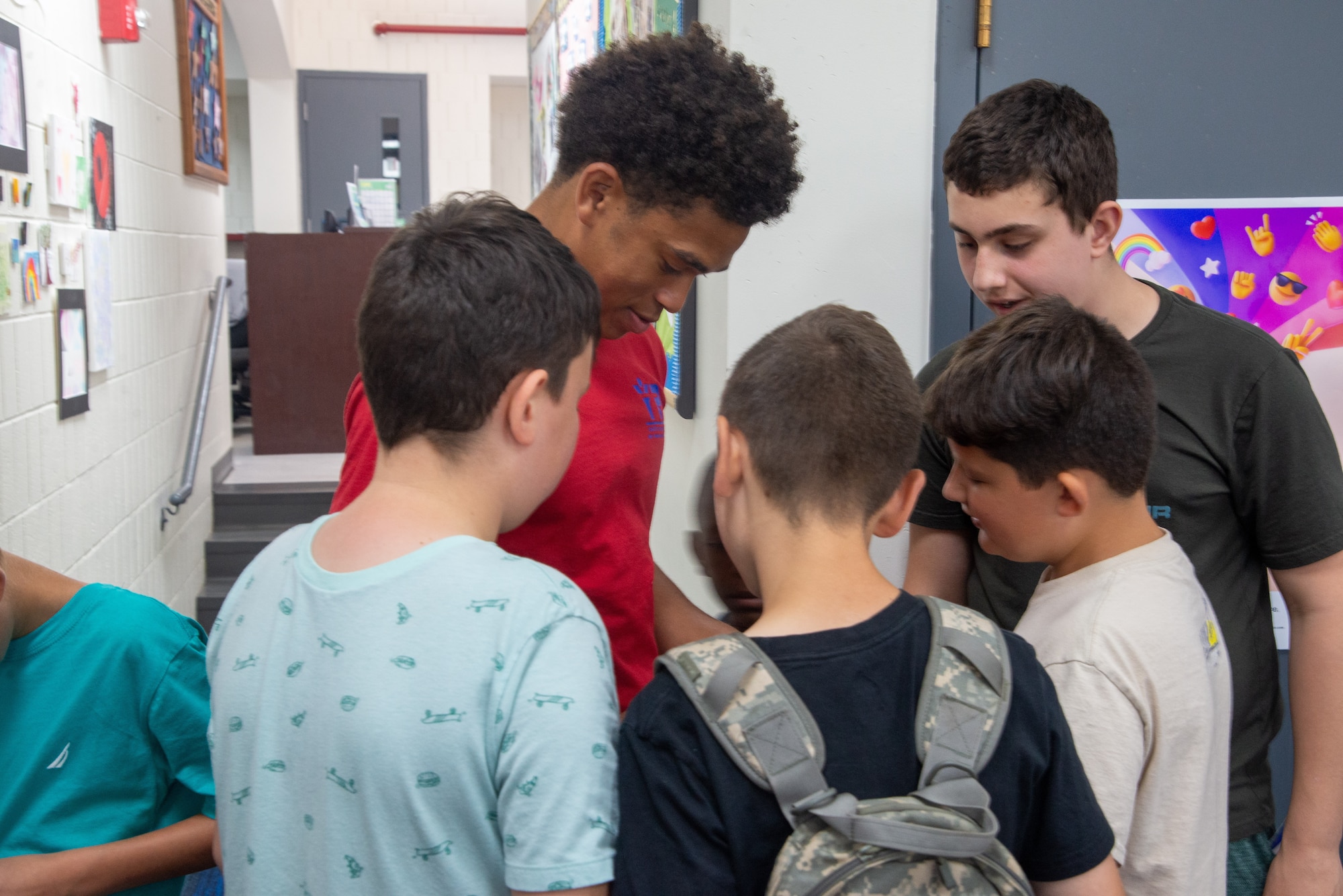 Julian Smith-Custer, Prairies Youth Center volunteer, shows children how to solve a Rubik’s Cube at the Prairies Youth Center (PYC) June 22. The PYC offers a wide variety of clubs and activities for youth ages 9 to 18. (U.S. Air Force photo by Airman 1st Class James Johnson)