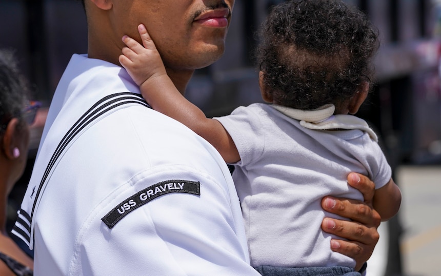 Sailor hugs baby