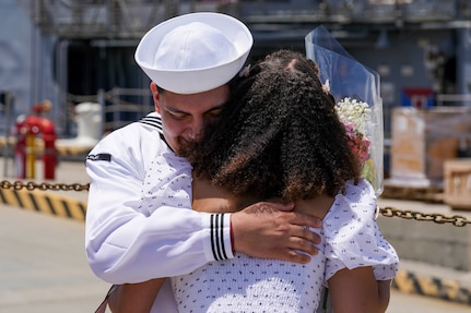 Sailor hugs spouse