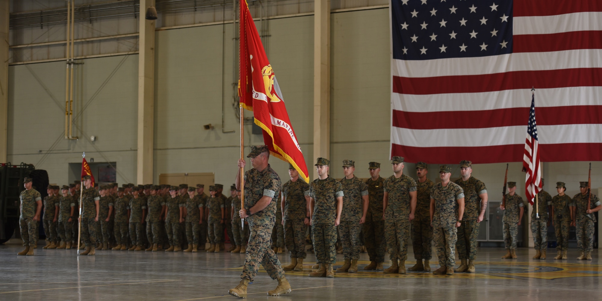 U.S. Marine Corps Master Gunnery Sgt. Darry Cross, Marine Corps Detachment senior enlisted leader, carries the Marine flag during the MCD change of command, at Goodfellow Air Force Base, Texas, June 24, 2022. The flag displays the eagle, globe and anchor representing the country the Marine Corps is faithful to, the area in which Marines operate, and the heritage of the service. (U.S. Air Force photo by Senior Airman Abbey Rieves)