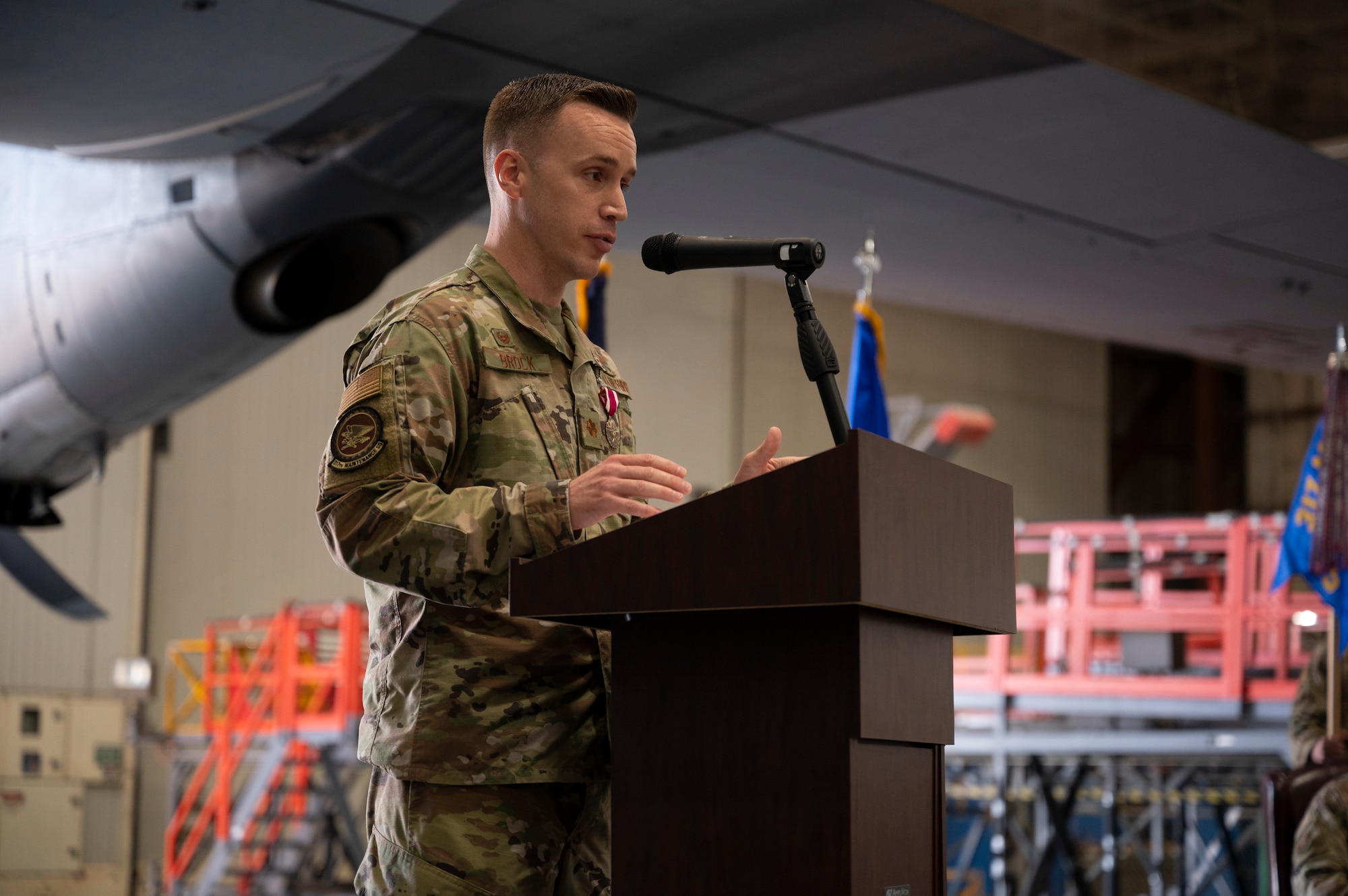 Maj. Andrew Brock, outgoing 317th Maintenance Group commander, gives his remarks during a change of command ceremony at Dyess Air Force Base, Texas, 17 Jun 2022. Brock, A C-130J Super Hercules pilot, took command of the 317th Maintenance Squadron in December of 2021. (U.S. Air Force photo by Senior Airman Reilly McGuire)