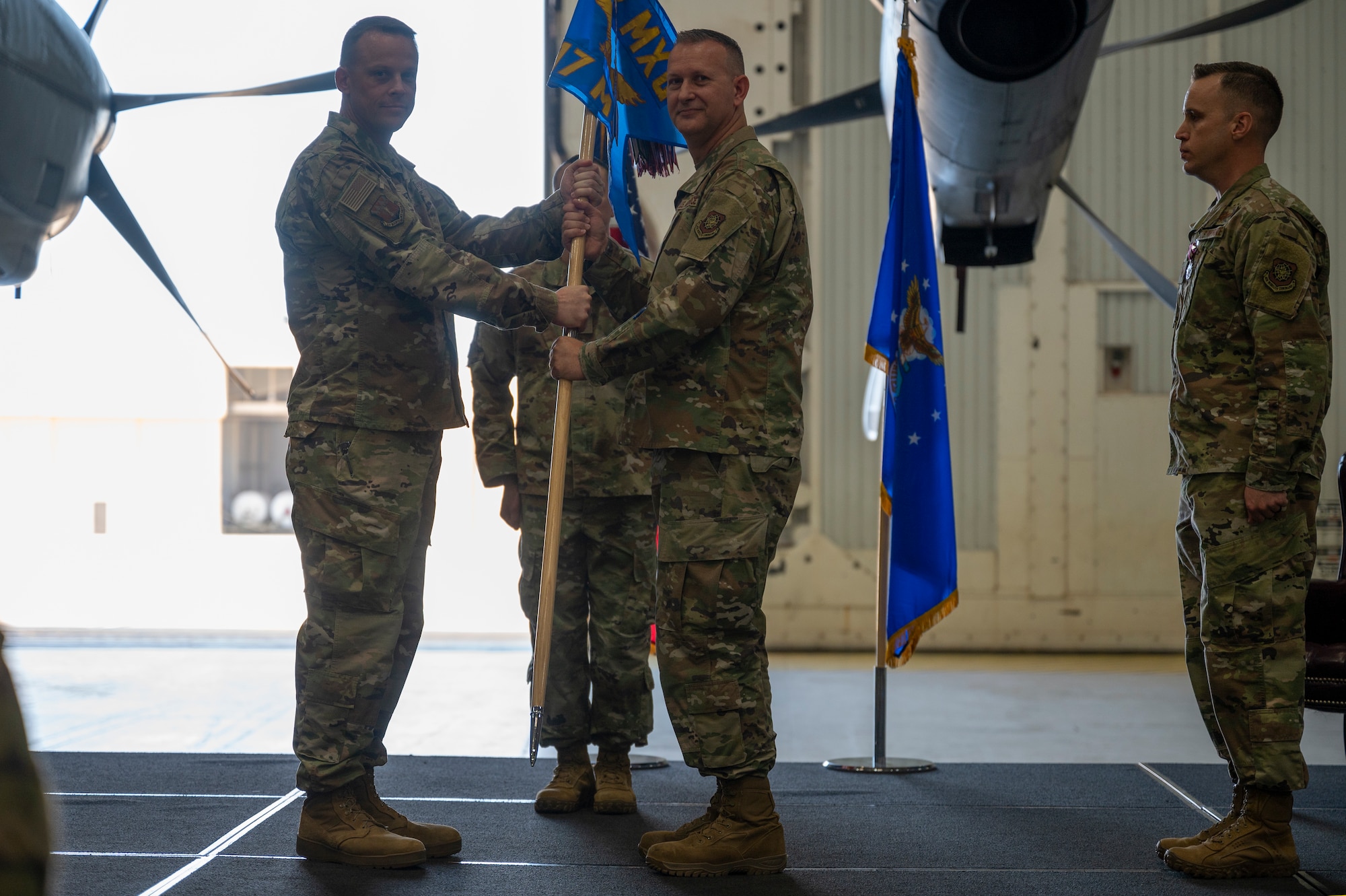 Maj. Daniel Finney, incoming 317th Maintenance Squadron commander, takes the guidon from Col. Jeffrey Darden, 317th Maintenance Group commander during a change of command ceremony at Dyess Air Force Base, Texas, 17 Jun 2022. Finney takes command of a squadron that is responsible  for performing on-and-off equipment maintenance on 28 C-130J aircraft and components supporting the group's global reach airlift mission. (U.S. Air Force photo by Senior Airman Reilly McGuire)