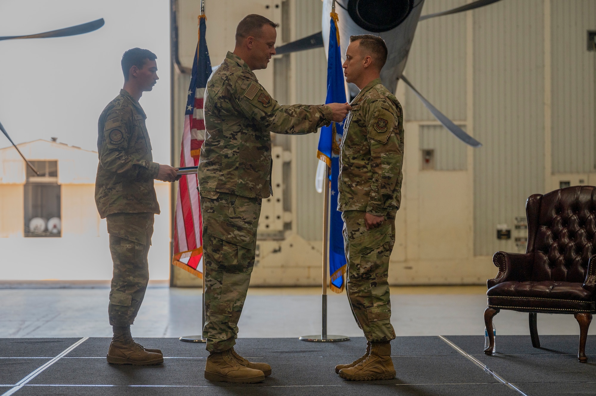 Col. Jeffrey Darden, 317th Maintenance Group commander, clips the Meritorious Service Medal onto Maj. Andrew Brock, outgoing commander of the 317th Maintenance Squadron at Dyess Air Force Base, Texas, 17 Jun 2022. During his command, Brock helped establish the Wing’s first Airman Tier 1 Training Program, which provides joint maneuver and defend-the-base warfighting skills for operating in contested environments. (U.S. Air Force photo by Senior Airman Reilly McGuire)