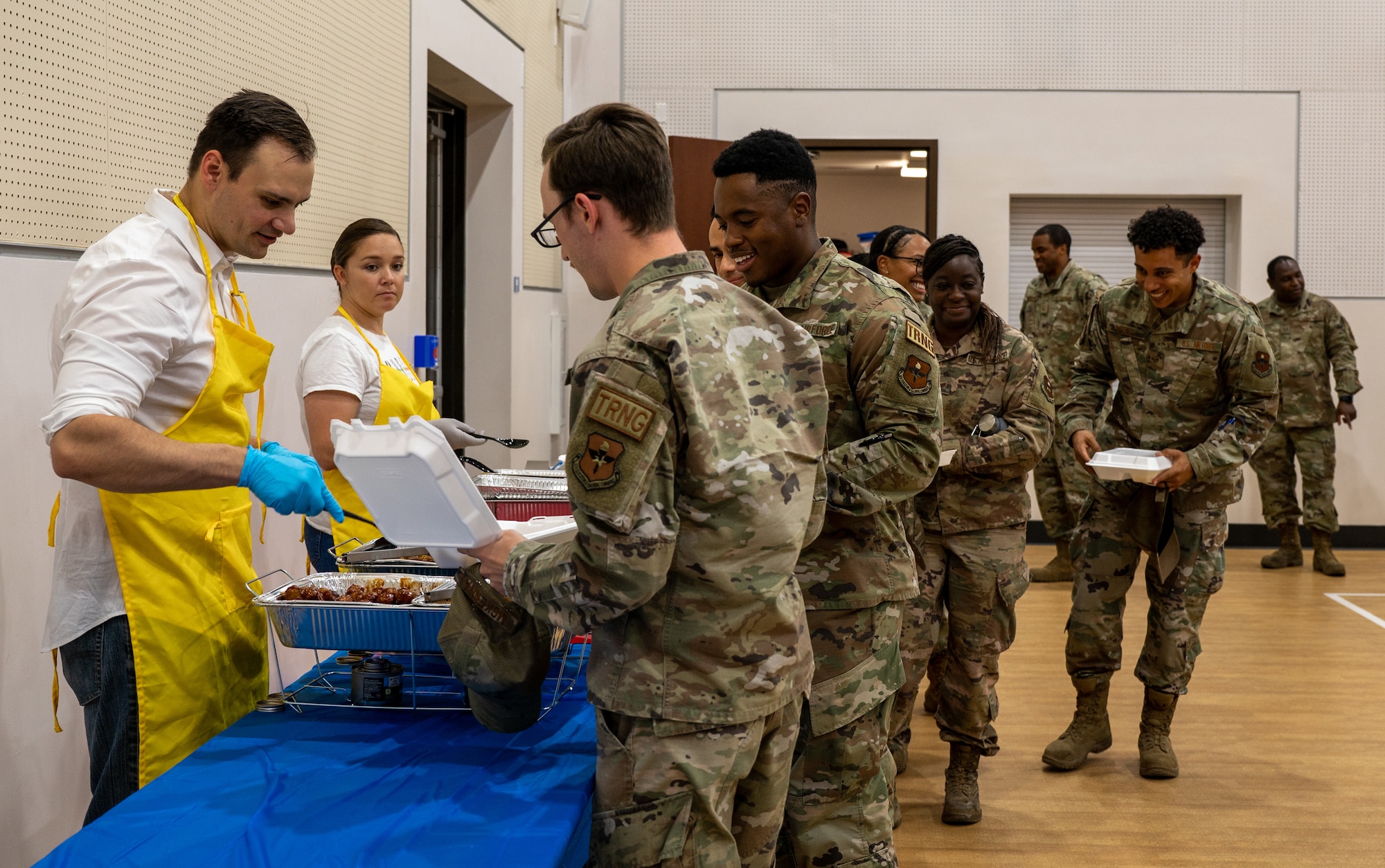 Airmen wait in line to receive food during a Juneteenth luncheon event, June 16, 2022, at Luke Air Force Base, Arizona.