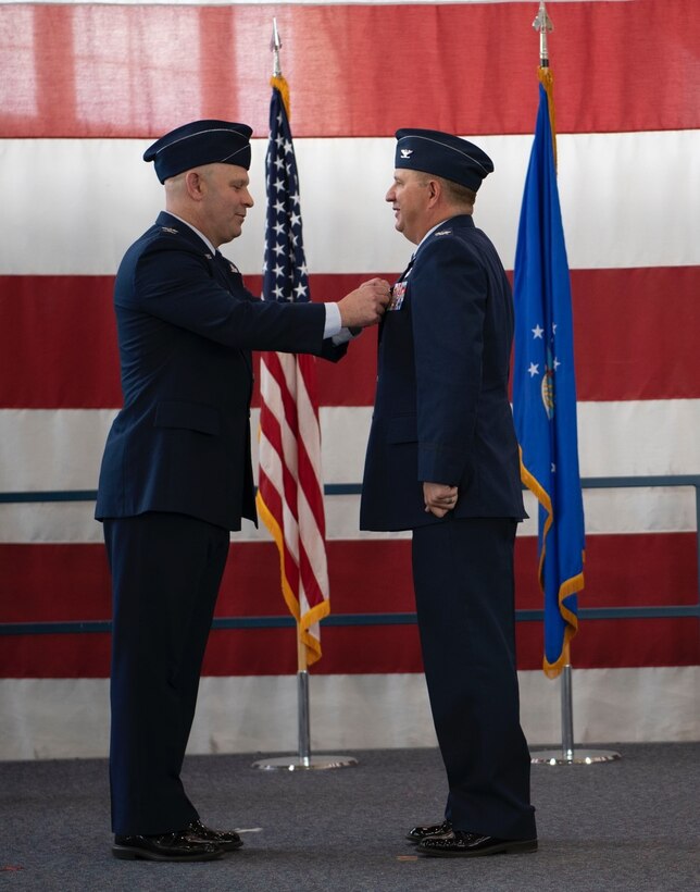 Col. Joseph Sheffield, the 28th Bomb Wing commander, relinquishes Col. Brady Vaira, the 28th Mission Support Group outgoing commander, of his command of the 28th Mission Support Group at Ellsworth Air Force Base, S.D., June 24, 2022.