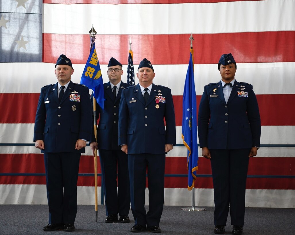 Col. Joseph Sheffield, the 28th Bomb Wing commander, left, Col. Brady Vaira, the 28th Mission Support Group outgoing commander, middle, and Col. Patrice Holmes, the 28th Mission Support Group incoming commander, right, stand during a change of command ceremony at Ellsworth Air Force Base, S.D., June 24, 2022.