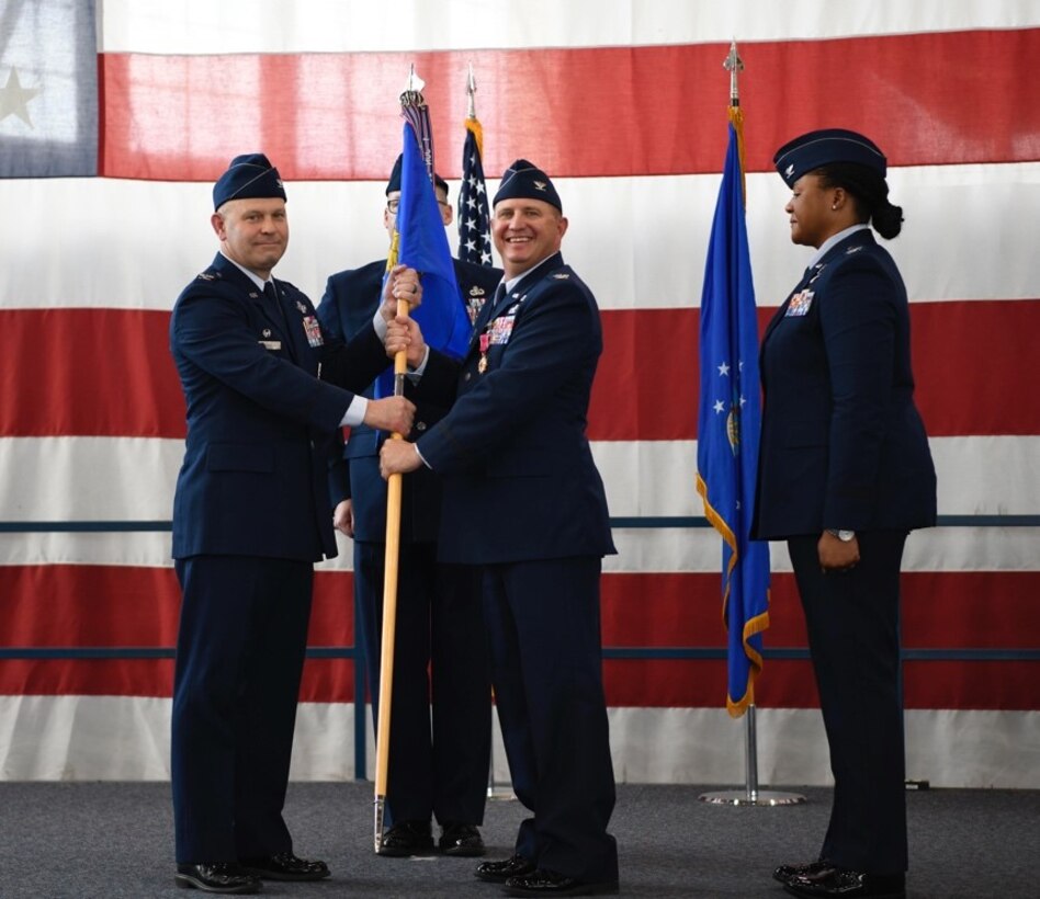 Col. Joseph Sheffield, the 28th Bomb Wing commander, relinquishes Col. Brady Vaira, the 28th Mission Support Group outgoing commander, of his command of the 28th Mission Support Group at Ellsworth Air Force Base, S.D., June 24, 2022.
