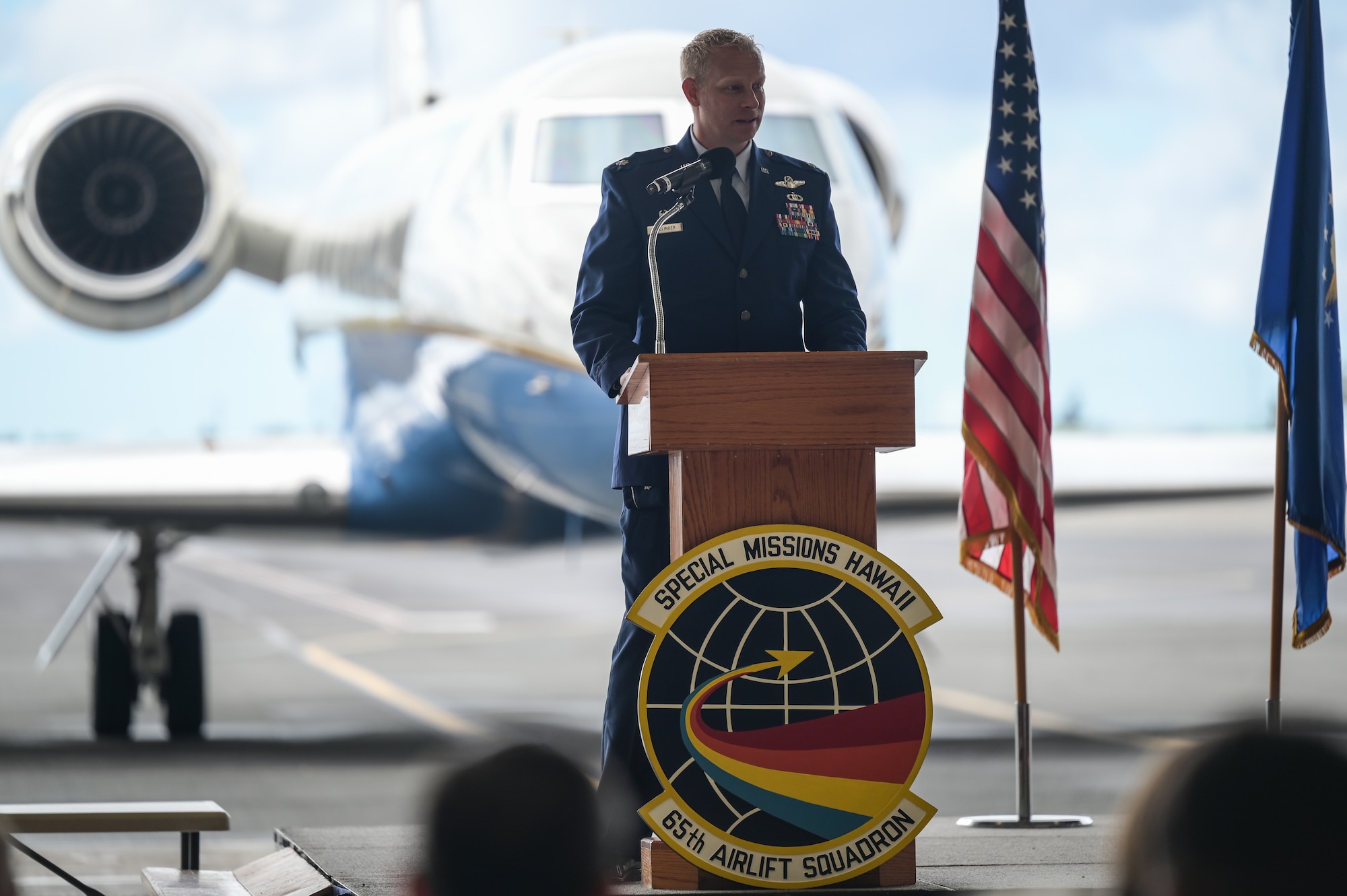 Lt. Col. Daniel Hellinger, 65th Airlift Squadron commander, gives a speech during a change of command ceremony at Joint Base Pearl Harbor-Hickam, Hawaii, June 24, 2022. Hellinger previously served as the 15th Wing Chief of Safety. (U.S. Air Force photo by Staff Sgt. Alan Ricker)