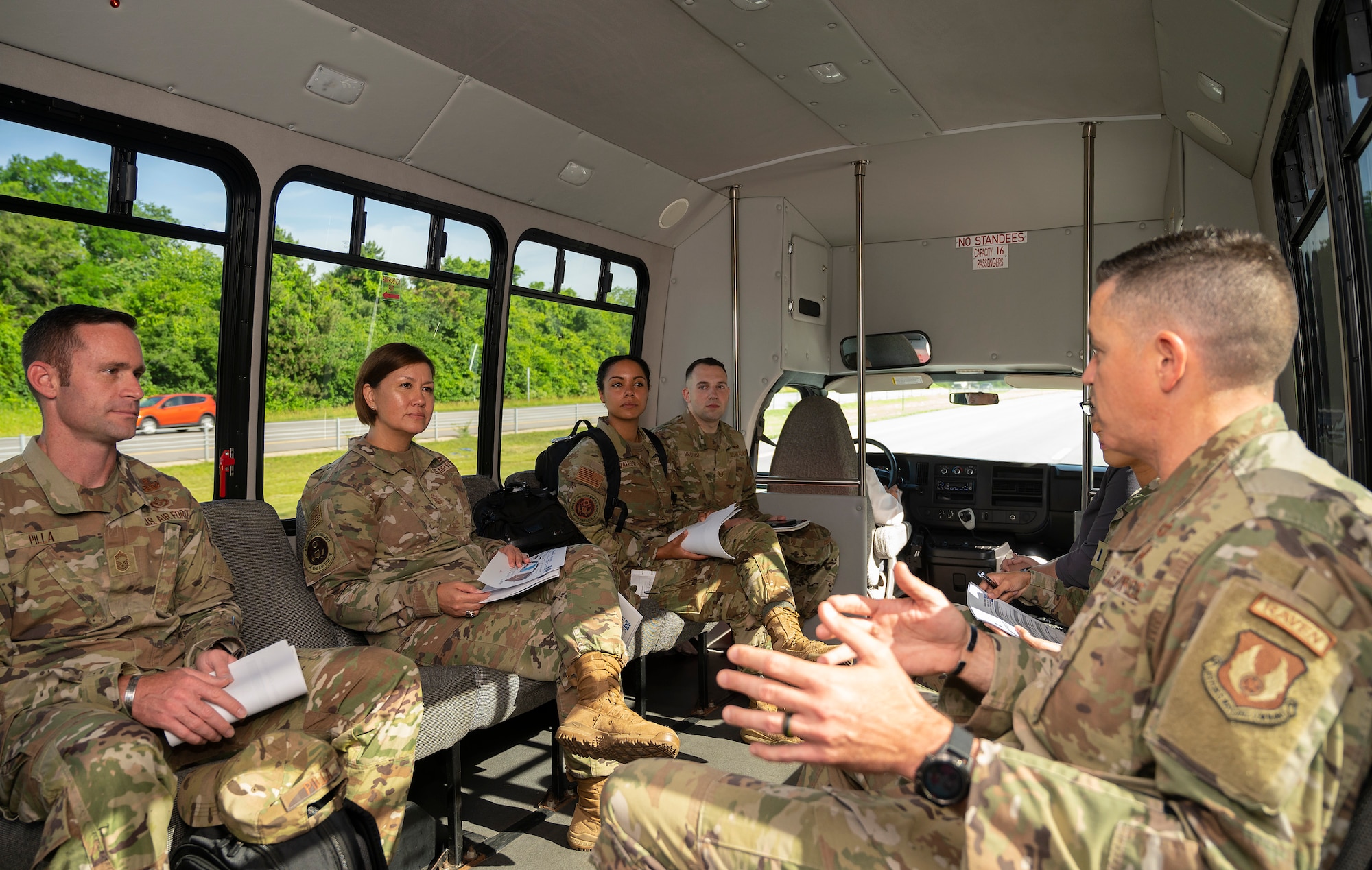 Chief Master Sgt. Jason Shaffer (right), 88th Air Base Wing command chief, and others brief Chief Master Sgt. of the Air Force JoAnne S. Bass on the surrey bus between stops on a tour June 16, 2022, at Wright-Patterson Air Force Base, Ohio. Bass was at Wright-Patt for the Corona Conference and took the opportunity to learn about innovative programs in the area. (U.S. Air Force photo by R.J. Oriez)