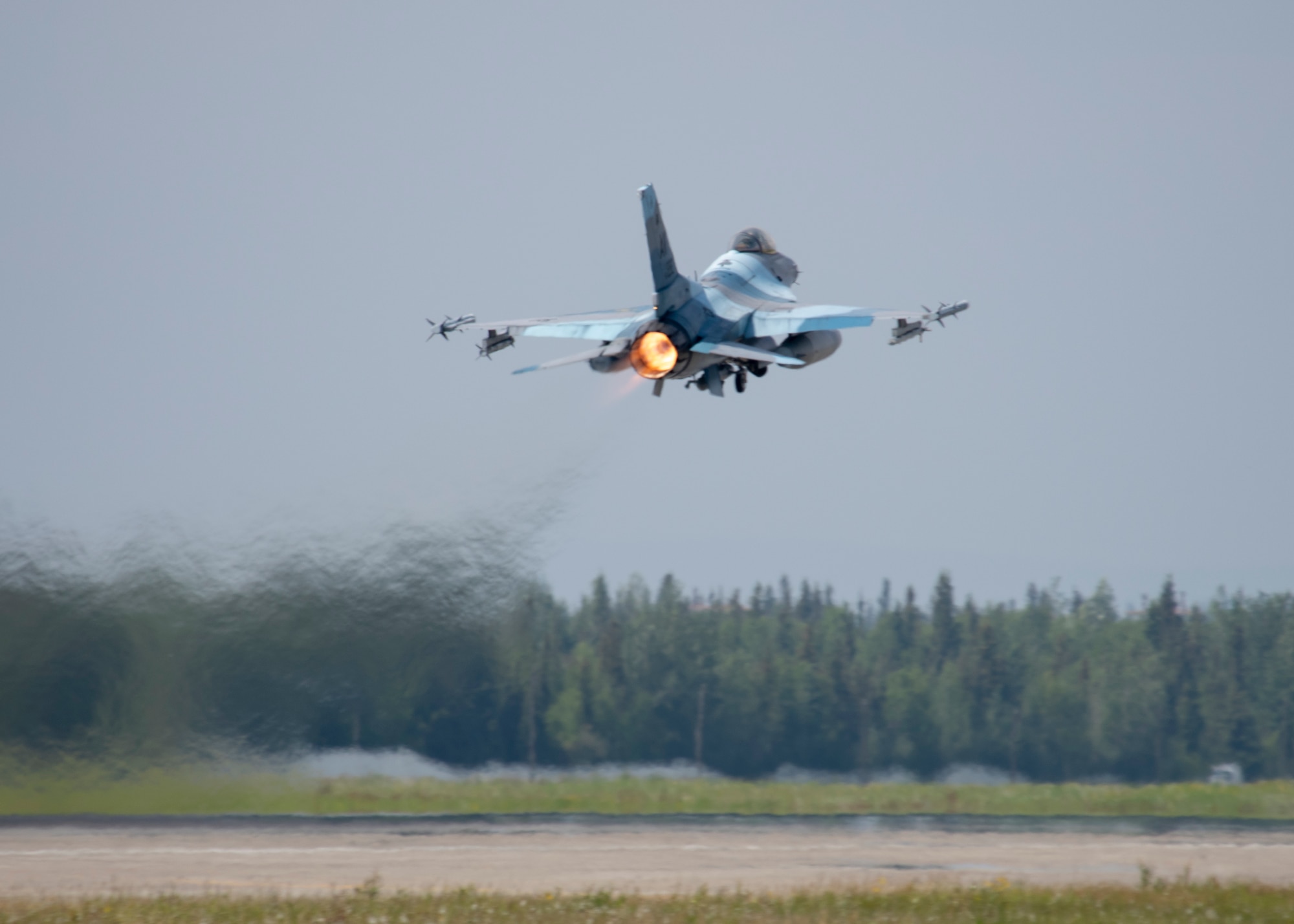 A U.S. Air Force 18th Aggressor Squadron F-16 Fighting Falcon takes-off for a training sortie as part of the Red Flag 22-2 exercise at Eielson Air Force Base, Alaska, June 16, 2022. The Aggressors are dedicated to playing the “red team” adversaries against “blue team” allies during Red Flag aerial training missions. The Red Flag Exercise was established in 1975 and serves as a two-week advanced aerial combat training exercise held multiple times a year by the USAF, alongside joint partner and allied air and ground forces. (U.S. Air Force photo by Staff Sgt. Ryan Lackey)