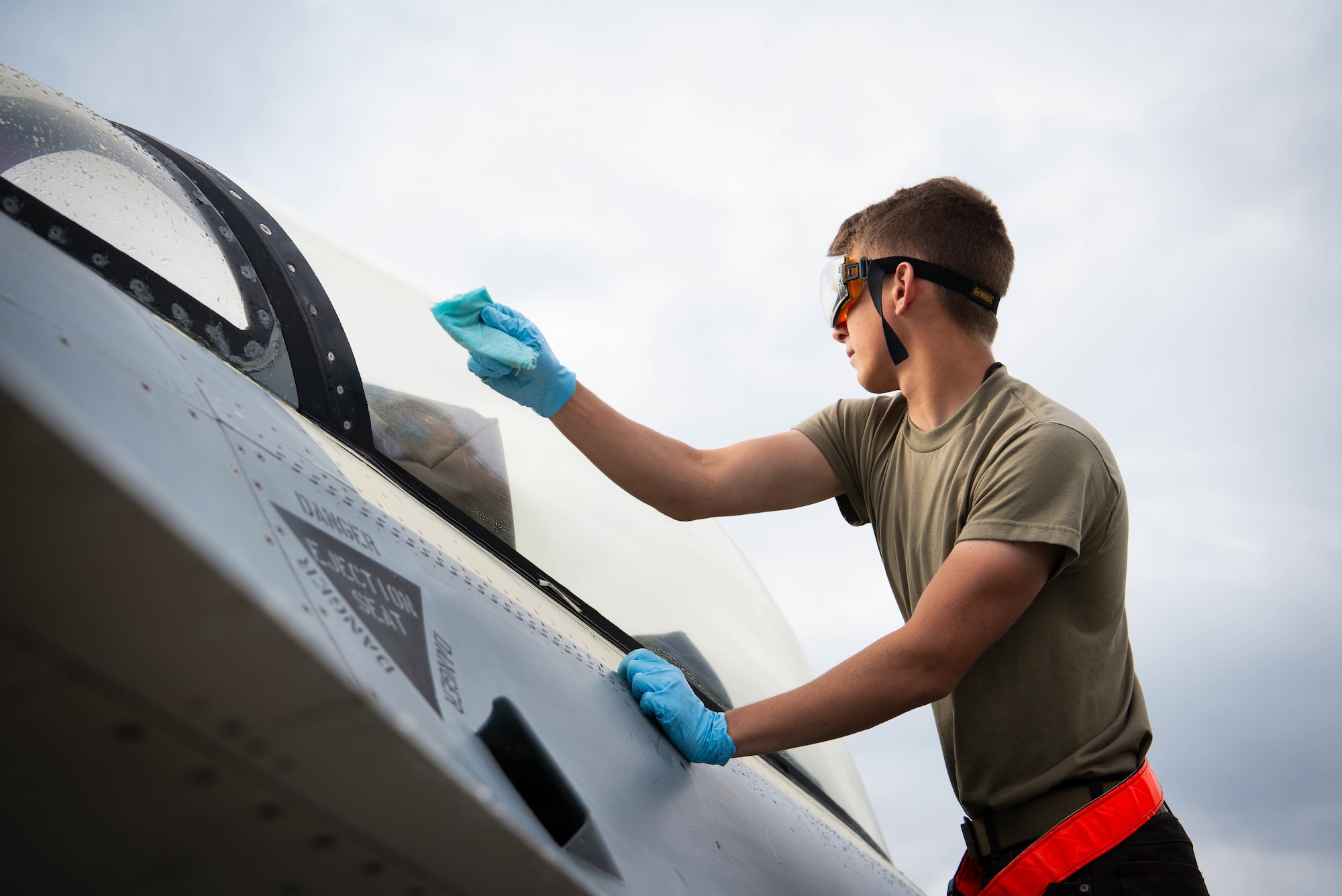 U.S. Air Force Airman 1st Class Rocky Clinch,18th Aircraft Maintenance Unit aircraft maintenance apprentice, wipes down the canopy on an F-16 FIghting Falcon fighter jet at Eielson Air Force Base, Alaska, June 20, 2022. Airmen assigned to the 18th AMU conduct checks and perform maintenance before, during and after jets are in the air. (U.S. Air Force photo by Airman 1st Class Ricardo Sandoval)