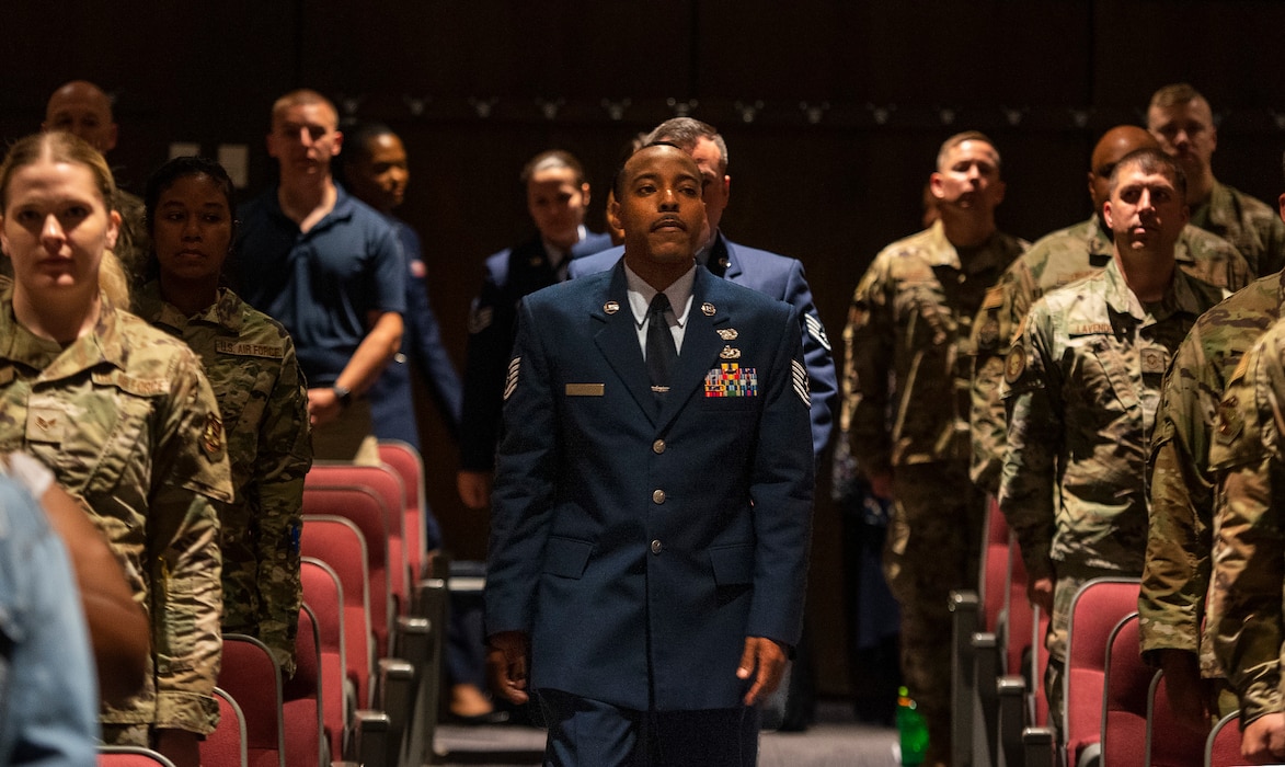 The Community College of the Air Force Wright-Patterson Class of 2022 marches into their graduation ceremony June 15, 2022, at the National Museum of the Air Force, Wright-Patterson Air Force Base, Ohio. Forty Airmen earned associate degrees from the world’s largest community college system.  (U.S. Air Force photo by R. J. Oriez)