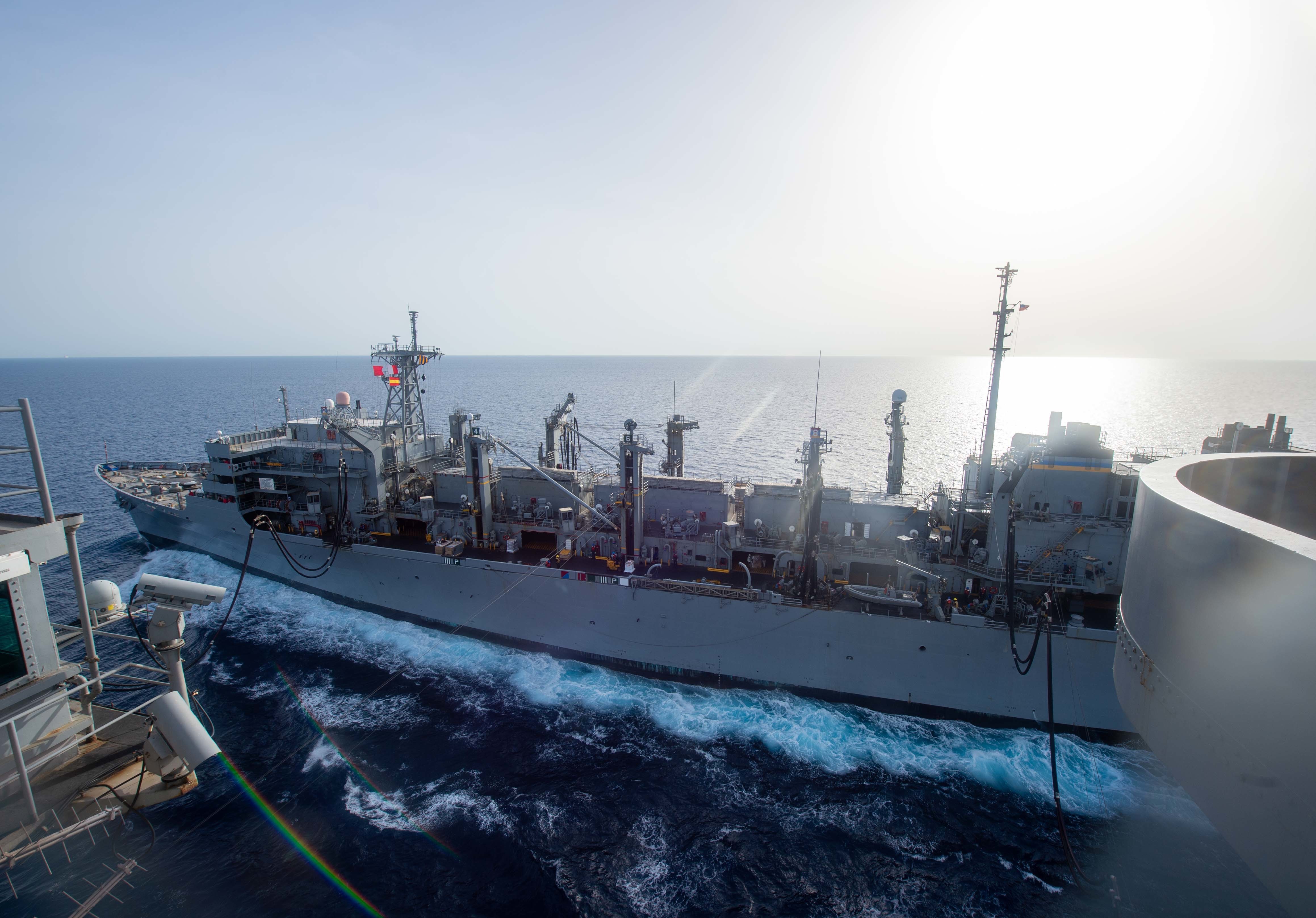 The Fast Combat Support Ship USNS Supply (T-AOE 6) transits alongside the Nimitz-class aircraft carrier USS Harry S. Truman (CVN 75) during a replenishment-at-sea, June 17, 2022.