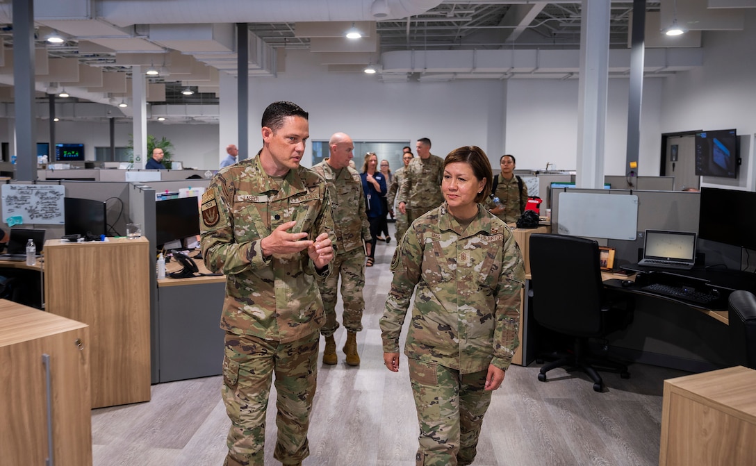 Air Force Lt. Col. Michael Lasher, Air Force Life Cycle Management Center Rapid Sustainment Office, briefs Chief Master Sgt. of the Air Force JoAnne S. Bass on the RSO mission during a tour June 16, 2022, in Dayton, Ohio. Bass was in Dayton for the Corona Conference at Wright-Patterson Air Force Base and took the opportunity to learn about innovative programs in the area. (U.S. Air Force photo by R.J. Oriez)