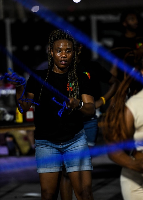 Master Sgt. Brooklyn Greenwood, a material management supervisor with the 380th Expeditionary Logistics Readiness Squadron, turns rope for Double Dutch jumpers during a Juneteenth celebration, June 19, 2022, at Al Dhafra Air Base, United Arab Emirates. The celebration was held to commemorate the emancipation of slaves in Texas, more than two years after the Emancipation Proclamation, and to provide Airmen an opportunity to learn more about United States history.