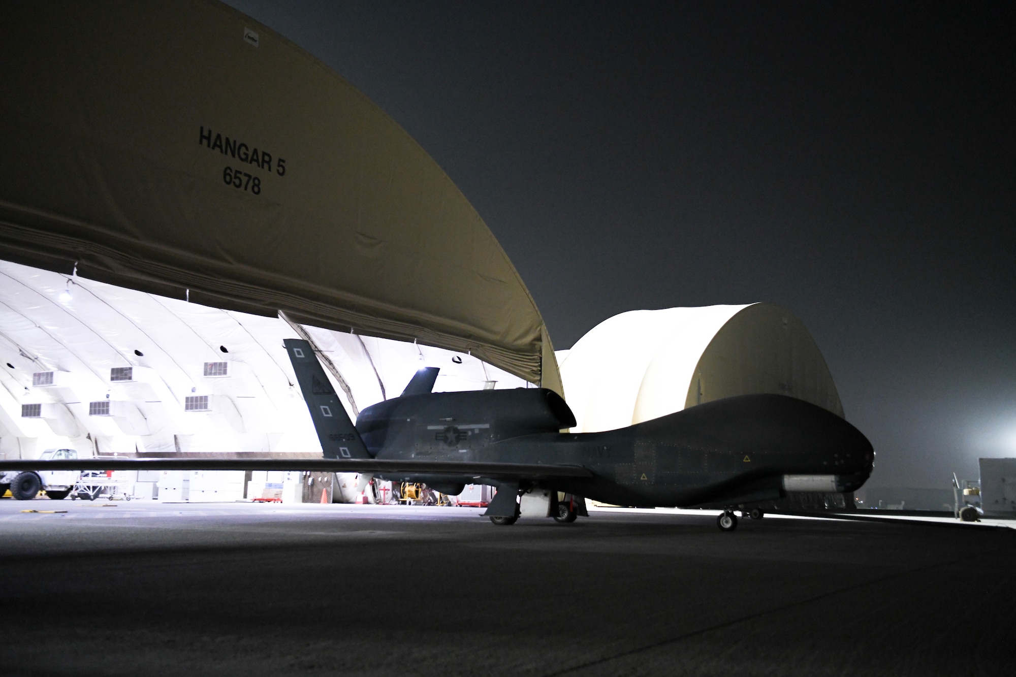The last U.S. Navy RQ-4 Global Hawk, attached to the Broad Area Maritime Surveillance Demonstrator mission, leaves Hangar 5 a final time, June 16, 2022, at Al Dhafra Air Base, United Arab Emirates. BAMS-D utilized the Global Hawk to identify intelligence gathering capabilities to be used in future U.S. Navy maritime operations with Triton Unmanned Aerial Vehicles.