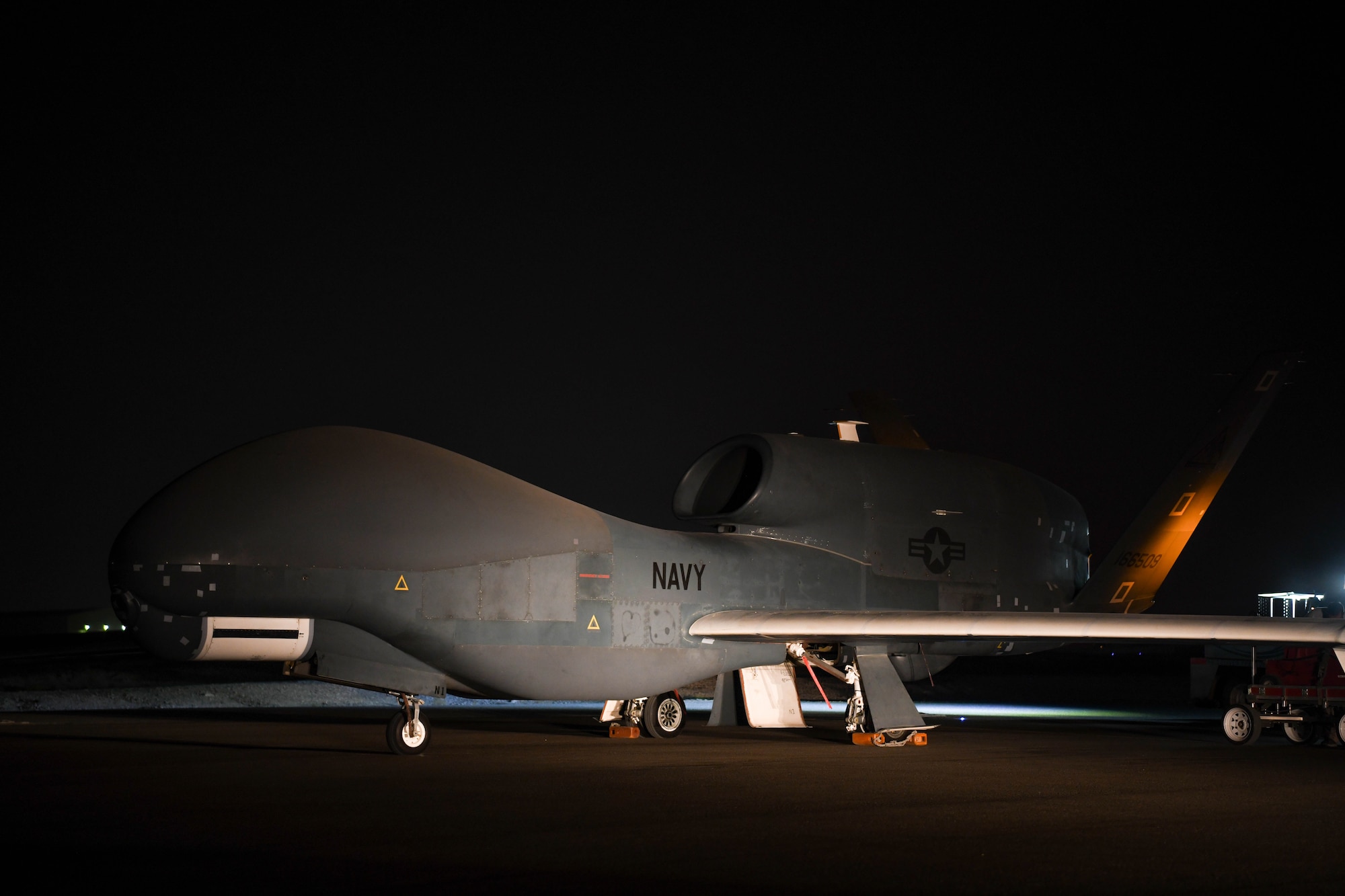 The last U.S. Navy RQ-4 Global Hawk, attached to the Broad Area Maritime Surveillance Demonstrator mission, undergoes preflight checks June 16, 2022, at Al Dhafra Air Base, United Arab Emirates. BAMS-D utilized the Global Hawk to identify intelligence gathering capabilities to be used in future U.S. Navy maritime operations with Triton unmanned aerial vehicles.