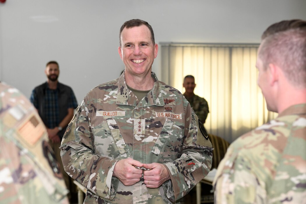 Lt. Gen. Gregory M. Guillot, the Ninth Air Force (Air Forces Central) commander, meets with Airmen from the 380th Air Expeditionary Wing June 3, 2022 at Al Dhafra Air Base, United Arab Emirates. Guillot is responsible for conducting air operations and developing contingency plans in a 21-nation area of responsibility, covering Central and Southwest Asia.