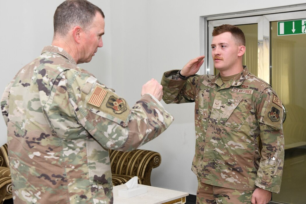 Airman 1st Class Blake Silvis, a locksmith assigned to the 380th Expeditionary Civil Engineer Squadron, renders a salute to Lt. Gen. Gregory M. Guillot, the Ninth Air Force (Air Forces Central) commander, June 3, 2022 at Al Dhafra Air Base, United Arab Emirates. Guillot coined five select Airmen for exemplifying the 380th AEW’s motto of “Always mission ready, Never Second Best.”