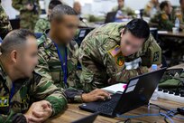 U.S. Army soldiers work with Moroccan Royal Armed Forces soldiers in an operations center.