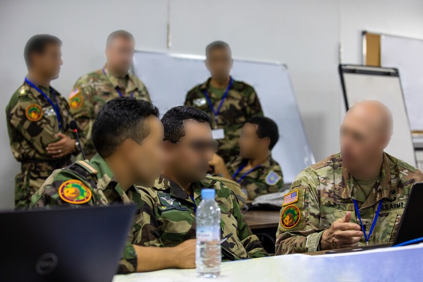 U.S. Army soldiers work with Moroccan Royal Armed Forces soldiers in an operations center.