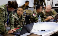 U.S. Army soldiers work with Moroccan Royal Armed Forces soldiers in an operations center.