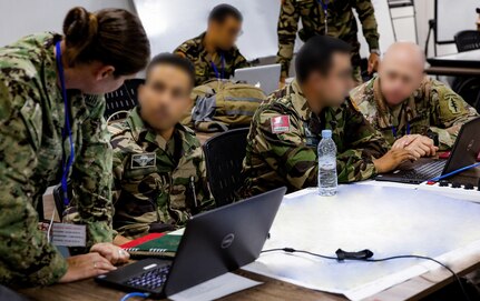 U.S. Army soldiers work with Moroccan Royal Armed Forces soldiers in an operations center.