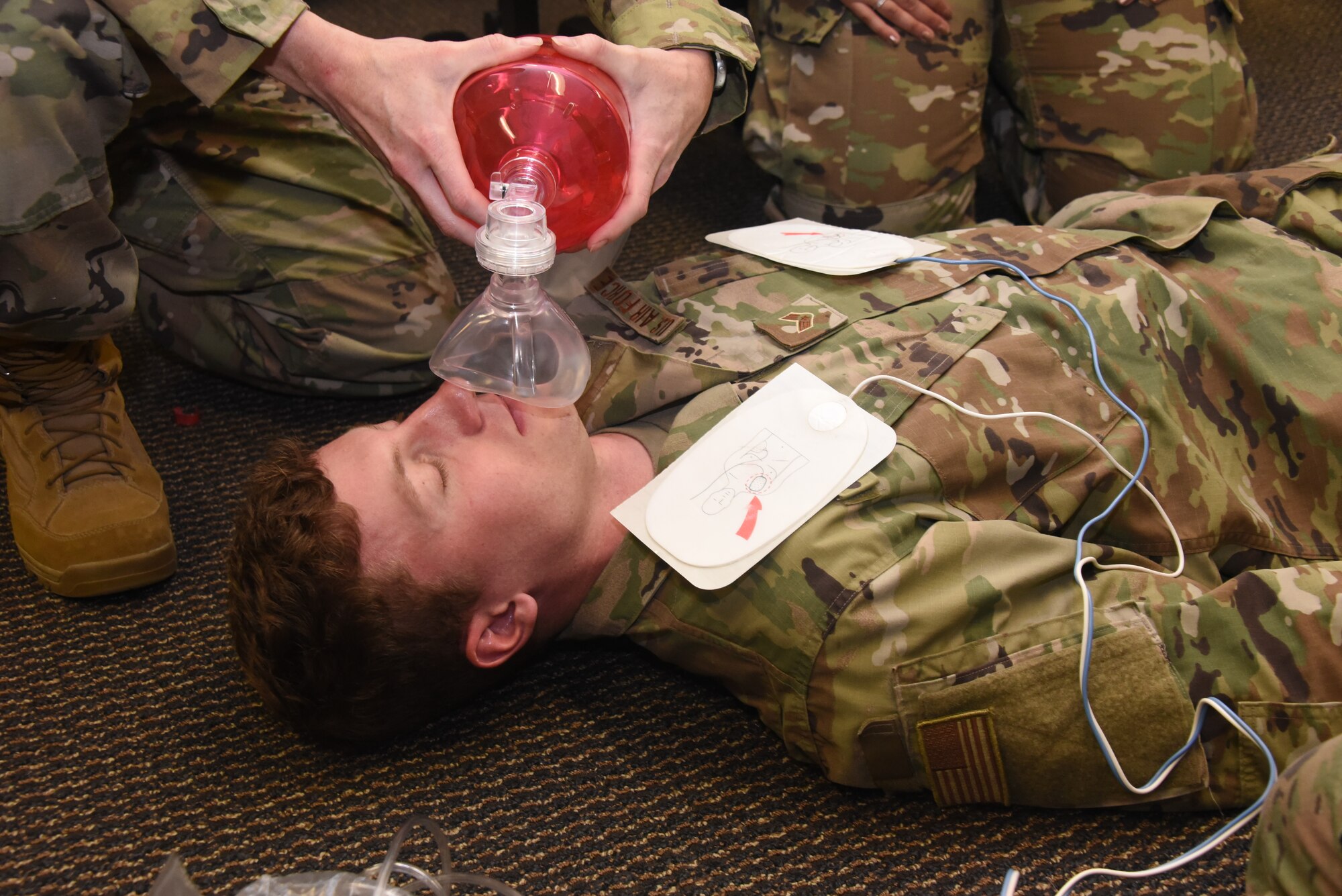 Senior Airman Charles Saulsbury has a bag valve mask used on him.
