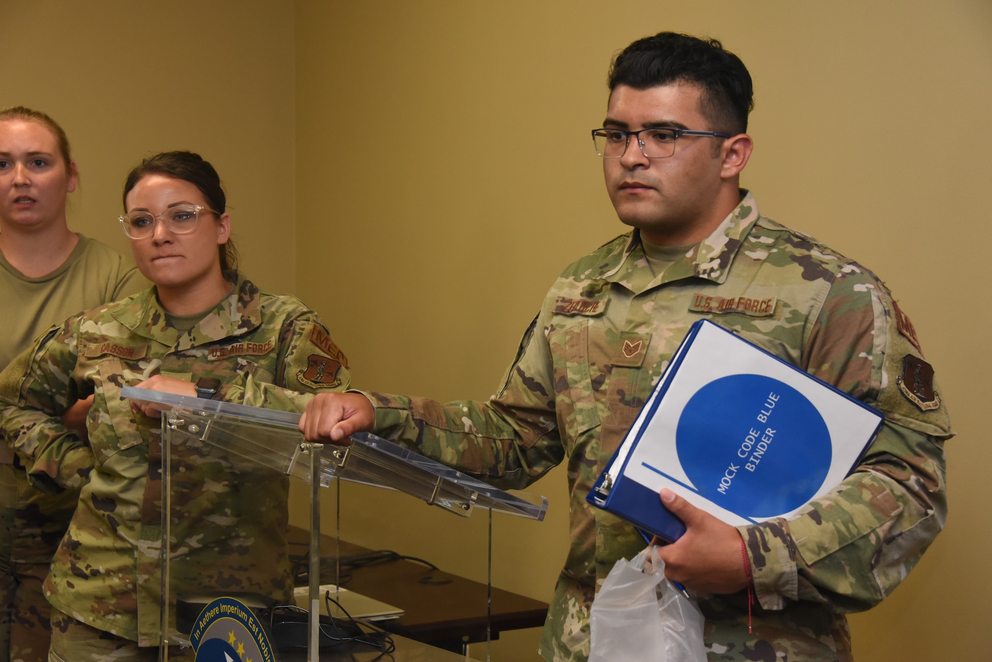 Zertuche observes medical group training while holding mock code blue binder