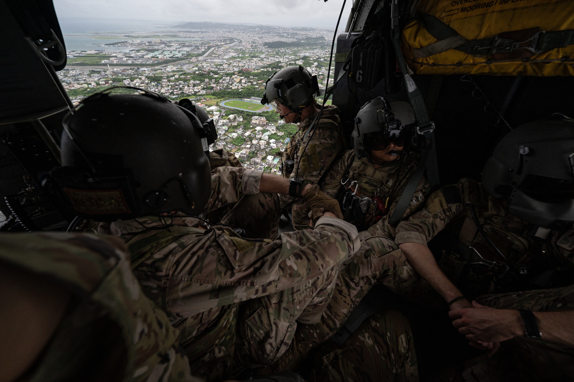 Airman ride in helicopter.