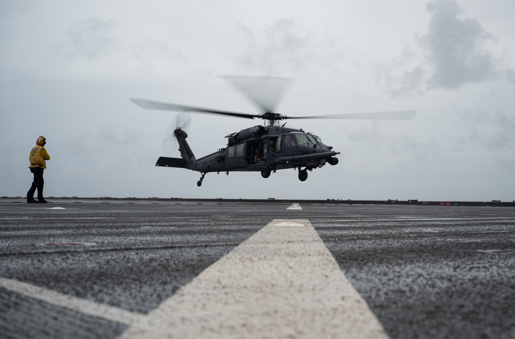 Helicopter lands on ship.