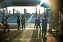 (June 17, 2022) Deck Department Sailors man a messanger line in the hangar bay of USS Harry S. Truman (CVN 75) during a replinishment-at-sea with USNS Supply (T-AOE 6), June 17, 2022. The Harry S. Truman Carrier Strike Group is on a scheduled deployment in the U.S. Naval Forces Europe area of operations, employed by U.S. Sixth Fleet to defend U.S., allied and partner interests.