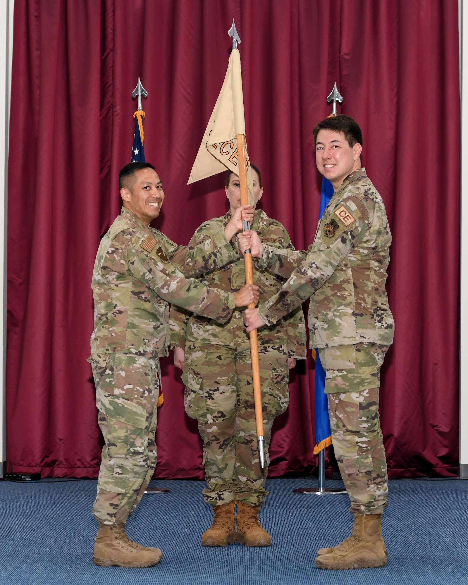 Colonel Todd T. Inouye, the previous 380th Expeditionary Mission Support Group commander and new 380th Air Expeditionary Wing A1/4/6/7 staff director, passes a guidon to Lt. Col. Nick Saccone, the new commander of the 380th Expeditionary Civil Engineer Squadron, during a change of command ceremony May 20, 2022, at Al Dhafra Air Base, United Arab Emirates. The passing of the guidon symbolizes the official transfer of authority from one commander to the next.
