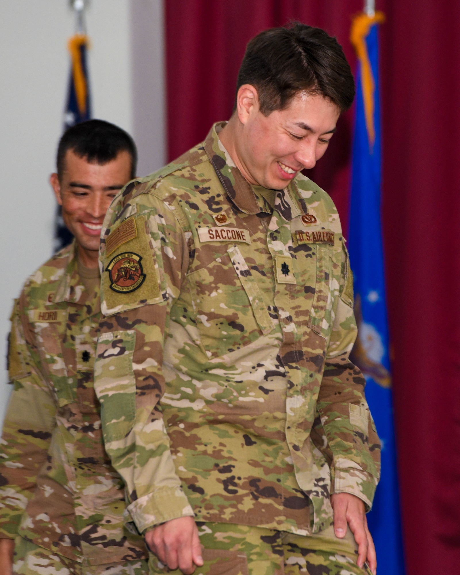 (From left) Lt. Col. Brandon Hori, the outgoing commander of the 380th Expeditionary Civil Engineer Squadron, and Lt. Col. Nick Saccone, the incoming commander, exit the stage after a formal change of command, May 20, at the Phantom Center, Al Dhafra Air Base, United Arab Emirates. The 380th ECES is home to a wide array of Air Force career fields that are paramount to any installation’s construction and maintenance.