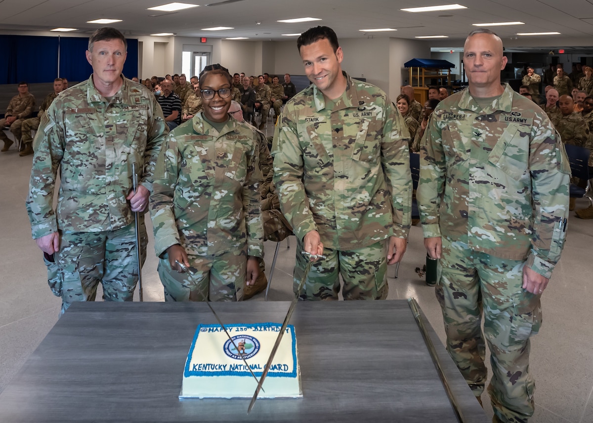 Brig. Gen. Jeffrey Wilkinson, left, the Kentucky National Guard’s assistant adjutant general for Air; Airman 1st Class Maryah Bridges, center left; Spc. John Stark, center right; and Col. Joe Gardner, the Kentucky Guard’s Chief of Staff for Army, cut a ceremonial cake during a celebration honoring the 230th birthday of the Kentucky Guard in Louisville, Ky., June 24, 2022. The organization was established in 1792 by Gov. Isaac Shelby, 19 days after the Commonwealth became the 15th state of the Union. (U.S. Air National Guard photo by Dale Greer)