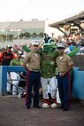 U.S. Marine Corps Col. Trevor Hall, left, Assistant Chief of Staff and Sgt. Jonathan T. Howard, right, a legal services specialist, both with Fleet Marine Force, Atlantic (FMFLANT), Marine Forces Command (MARFORCOM), Marine Forces Northern Command (MARFOR NORTHCOM), meet Triton, the Norfolk Tides minor-league baseball mascot, at Harbor Park Stadium, Norfolk, Virginia, June 18, 2022. U.S. Marines with FMFLANT, MARFORCOM, MARFOR NORTHCOM participated in the baseball game to represent the Marine Corps presence in Naval Station Norfolk, the biggest naval base in the world. Due to the military being an integral part of the Hampton Roads community, the Norfolk Tides hosts several military appreciation nights and military themed seasons in honor of the U.S. Armed Forces. (U.S. Marine Corps photo by Lance Cpl. Angel Alvarado)