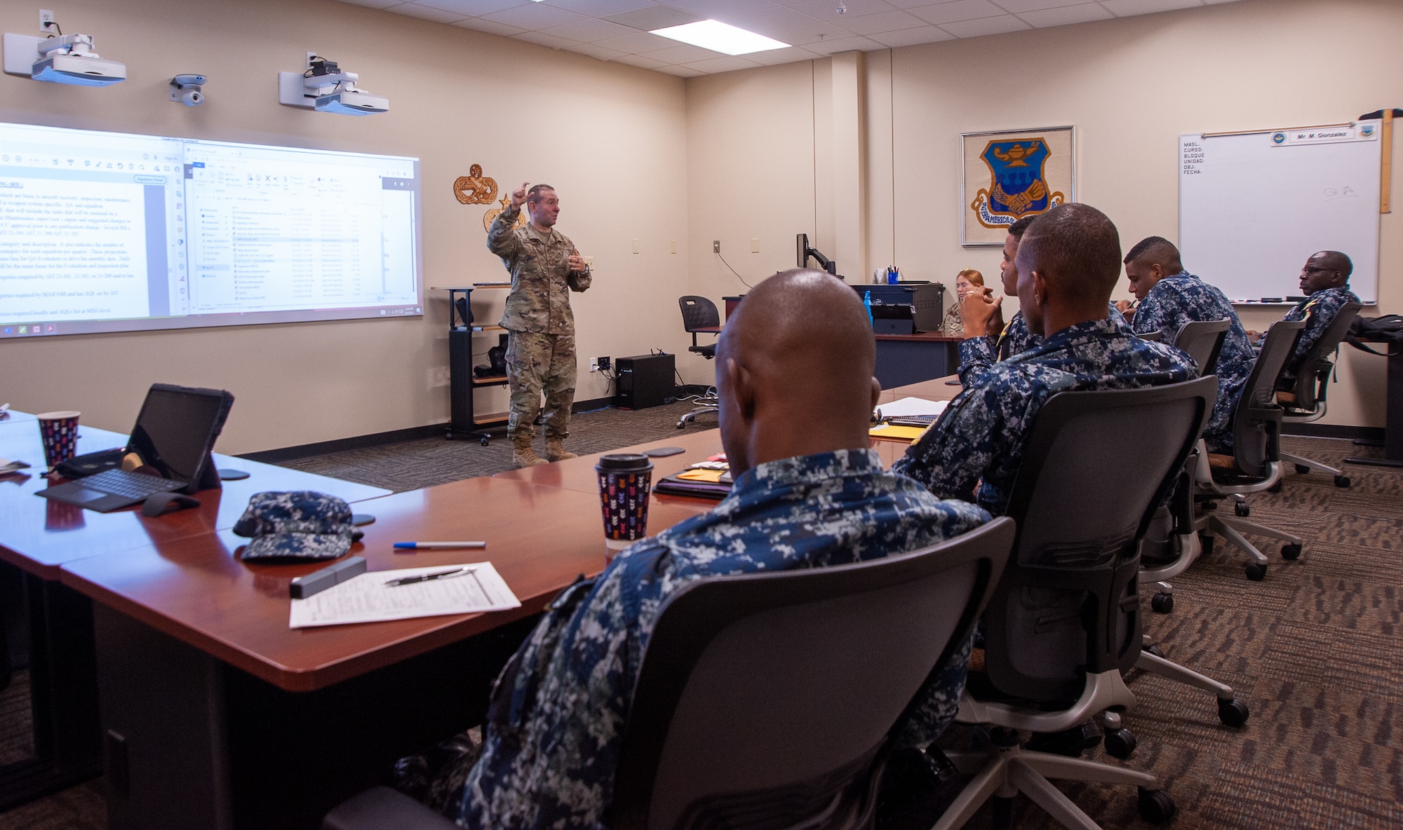 a U.S. Air Force airman is teaching a class of Jamaican Defence Force members