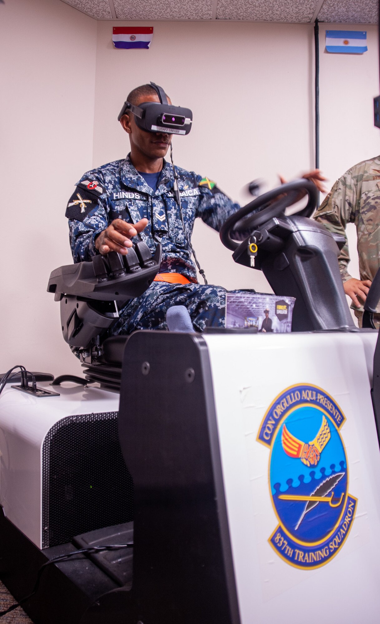 Jamaican Defence Force corporal drives a forklift simulator