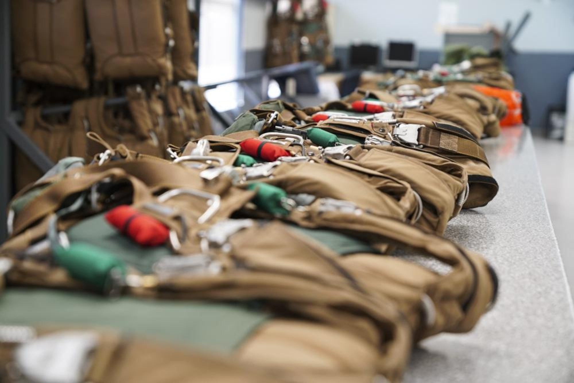 Aircrew flight equipment specialists with the 1st Special Operations Support Squadron pack low-profile emergency parachutes for aircrew members, at Hurlburt Field, Florida, June 14, 2022.