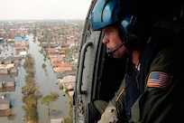 Coast Guard Petty Officer 2nd Class Shawn Beaty, 29, of Long Island, N.Y., looks for survivors in the wake of Hurricane Katrina, Aug. 30, 2005.