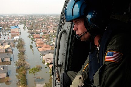 Coast Guard Petty Officer 2nd Class Shawn Beaty, 29, of Long Island, N.Y., looks for survivors in the wake of Hurricane Katrina, Aug. 30, 2005.